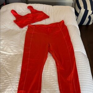 Women's Fabletics bright orange workout set leggings and sports bra
